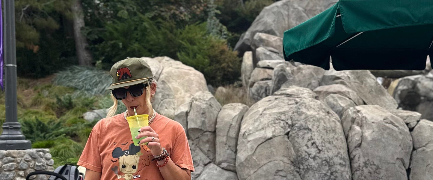 Person in a themed outfit with a backpack in front of rocky landscape